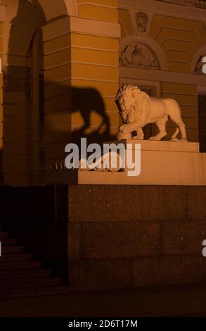 San Pietroburgo, Russia - 17 novembre 2018: Statua di un leone che tiene una palla con illuminazione notturna vicino al Museo russo orientamento verticale Foto Stock