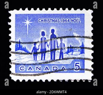 MOSCA, RUSSIA - 13 MAGGIO 2018: Un francobollo stampato in Canada mostra Famiglia, serie di Natale, circa 1964 Foto Stock