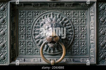 Chiusura di una testa di leone di metallo su un batticalcagno di porta Alla Cattedrale di Colonia in Germania Foto Stock