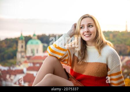 Giovane donna sul tetto rosso di fondo nella città vecchia di Praga, repubblica Ceca Foto Stock