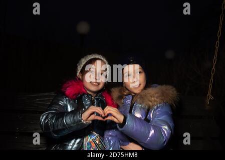 Due giovani belle amiche camminano in inverno Foto Stock
