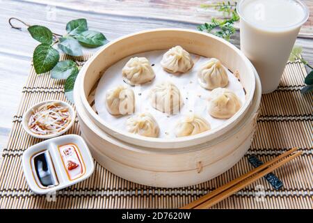 Xiaolongbao al vapore servito in un tradizionale cestino per la cottura a vapore Foto Stock