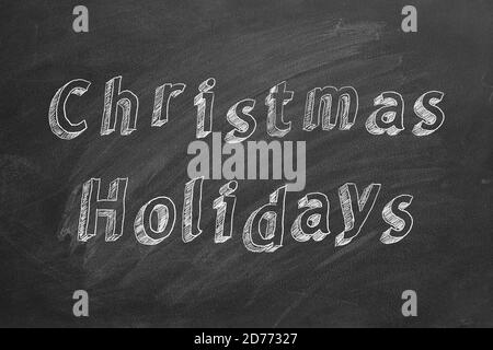 Testo di disegno a mano vacanze di Natale su lavagna Foto Stock