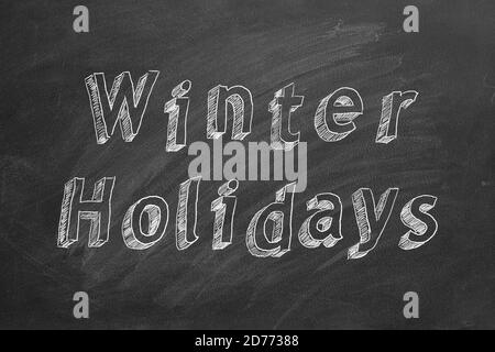 Testo del disegno a mano Vacanze invernali sulla lavagna Foto Stock