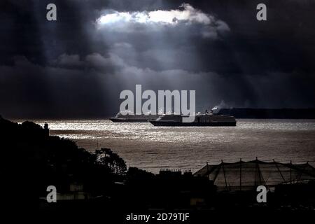 Due enormi navi da crociera olandesi sono illuminate dai raggi solari su Torbay a Devon, Regno Unito. Le navi sono due delle diverse navi da crociera attualmente ancorate a Torbay, prive di passeggeri durante la pandemia di Coronavirus. Nota: Le due navi sono la MS Westerdam e la MS Nieuw Statendam. Entrambi sono di proprietà della Holland America Line. Foto Stock