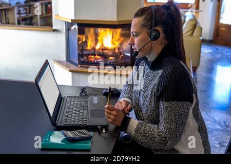 Lavoro intelligente. Giovane donna che lavora su un computer portatile da casa, durante la crisi sanitaria del Covid-19 Foto Stock