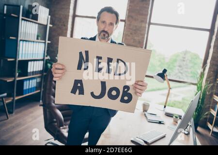 Foto di disperazione di moody triste licenziato licenziato lavoratore bello tizio maturo tenere cartello poster cercare nuovo lavoro ultimo lavoro giorno mondo crisi sul posto di lavoro sparato Foto Stock