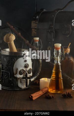 Pozioni magiche in bottiglie, bare e bacchetta magica su sfondo di legno scuro Foto Stock