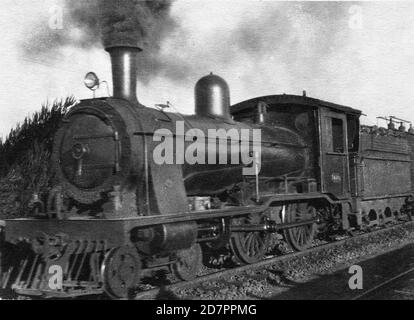 Ferrovie del Governo del Capo 3a Classe 4-4-0 del 1903 n. 49 (Wynberg Tender) vicino al lago Germiston su un treno a motore tra Germiston e Wattles ca. 1930 Foto Stock