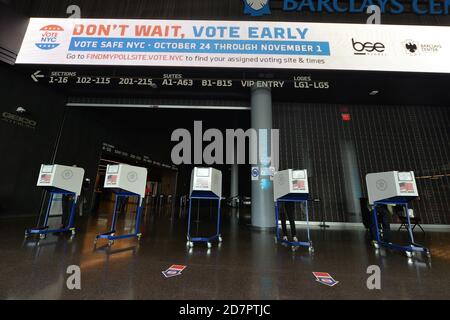 New York City, Stati Uniti. 24 Ott 2020. Le persone si levano in piedi dietro le cabine di voto per la privacy per compilare i loro voti all'interno del Barclays Center il primo giorno delle prime elezioni presidenziali del 2020, nel quartiere di New York City di Brooklyn, NY, 24 ottobre 2020. In un accordo raggiunto con l'NBA, arene sportive come il Barclays Center saranno utilizzati come siti di polling, uno dei 88 siti di lancio del voto precoce, questa la prima volta nella storia New York partecipa alle votazioni anticipate. (Anthony Behar/Sipa USA) Credit: Sipa USA/Alamy Live News Foto Stock