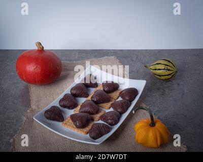 biscotti a forma di cuore al cioccolato su un piatto bianco di fondo, che abbassano il tempo zucche Foto Stock