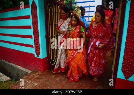 Chitrakshi Chakraborty età 10 anni e 9 giorni vestita come Kumari, è una giovane ragazza vergine che è adorata come parte dei rituali di Durga Puja. Il festival è il più grande evento religioso per gli indù bengalesi. Gli indù credono che la dea Durga simbolizzi il potere e il trionfo del bene sul male. Agartala, Tripura, India. Foto Stock