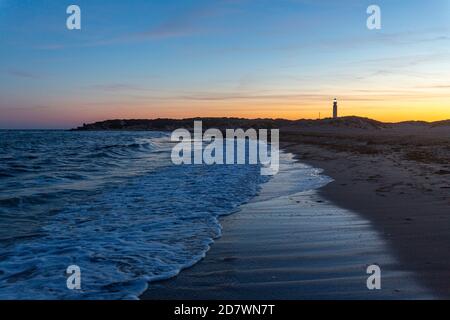 Playa de los Caños de Meca al crepuscolo e faro, Capo Trafalgar, provincia di Cadice, Andalusia, Spagna Foto Stock