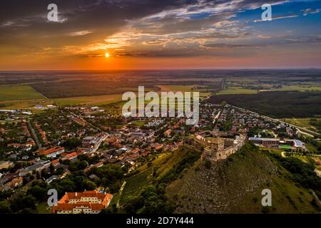 Sumeg, Ungheria - Vista panoramica aerea del famoso Castello di Sumeg nella contea di Veszprem al tramonto con nuvole colorate e colori drammatici del sole Foto Stock