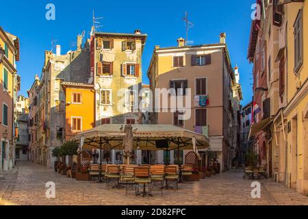 Passeggiata mattutina nella vuota città croata di Rovigno. Pittoresca e stretta acciottolata Strade, facciate colorate, piccoli negozi, bella città europea. Estate Foto Stock