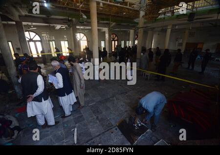 Peshawar, Pakistan. 27 Ott 2020. I soccorritori pakistani e i poliziotti esaminano il sito di un'esplosione di bombe in un seminario islamico a Peshawar, in Pakistan, il 27 ottobre 2020. Una potente bomba scoppiò nel seminario islamico alla periferia della città pakistana nordoccidentale di Peshawar martedì mattina, uccidendo alcuni studenti e ferendone decine altri, ha detto la polizia e un portavoce dell'ospedale. (Foto di Hussain Ali/Pacific Press/Sipa USA) Credit: Sipa USA/Alamy Live News Foto Stock