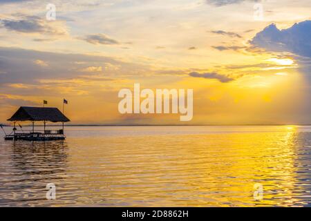 Pontone galleggianti in acqua al tramonto, Thailandia Foto Stock