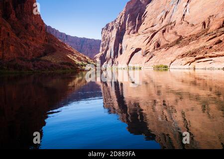 Le pareti del Canyon si riflettono sulla superficie vetrosa del fiume Colorado a Horseshoe Bend. Foto Stock