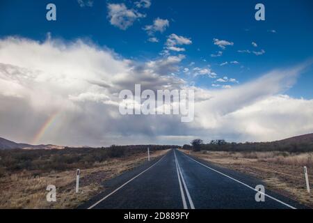 Rainbow e tempesta nuvole sopra Namatjira Drive vicino Mt Sonder / Rwetyepme (1380m) Foto Stock