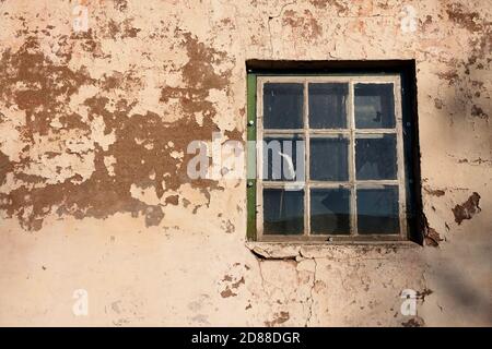vecchia finestra rotta al fienile in pietra e cemento Foto Stock