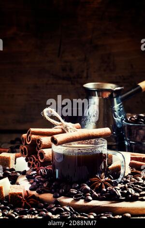 Espresso, macchina per il caffè, chicchi di caffè, spezie, zucchero, sfondo in legno vintage, messa a fuoco selettiva Foto Stock