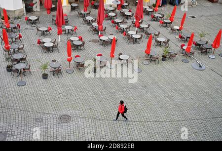 Monaco, Germania. 28 Ott 2020. Una passeggiata pedonale passa davanti a un caffè vuoto nella zona pedonale. Credit: Peter Kneffel/dpa/Alamy Live News Foto Stock