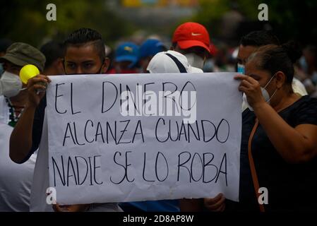 San Salvador, El Salvador. 28 Ott 2020. I manifestanti tengono in mano i segni e il canto durante una protesta che chiede il pagamento del fondo FODES.i pagamenti per oltre 240 milioni di dollari sono ancora stati effettuati dal governo e dai comuni rischiano di perdere l'elettricità e altri servizi municipali. Credit: Camilo Freedman/ZUMA Wire/Alamy Live News Foto Stock