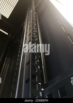 Primo piano di frammenti di rack industriale da 19" (rack da 19") per apparecchiature o server di telecomunicazione Foto Stock