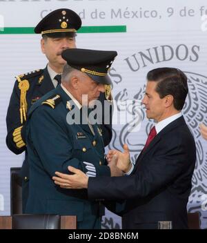 Il presidente messicano Enrique pena Nieto, a destra, abbraccia il ministro della Difesa Gen. Salvador Cienfuegos Zepeda durante una cerimonia che celebra il 104esimo anniversario della fedeltà il 9 febbraio 2017 a Città del Messico, Messico. Cienfuegos è stato arrestato il 16 ottobre 2020 all'aeroporto internazionale di Los Angeles e accusato di corruzione legata alla droga. Foto Stock