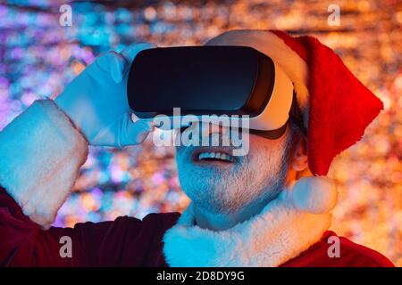 Babbo Natale indossare occhiali giocare in un videogioco virtuale Foto Stock