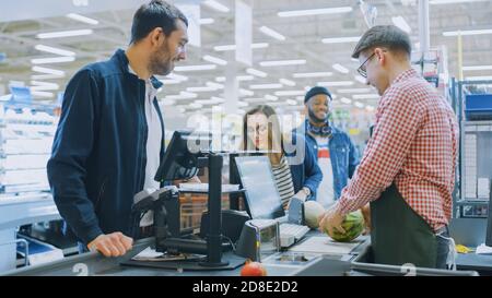 Presso il supermercato: Cassa professionale Cassa effettua la scansione di generi alimentari e prodotti alimentari. Centro commerciale pulito e moderno. Foto Stock