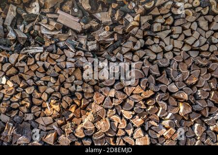 Un stock di legno destinato per caminetti o stufe a legna. Immagazzinato all'aria aperta per asciugare. Che è usato spesso in inverno. Foto Stock