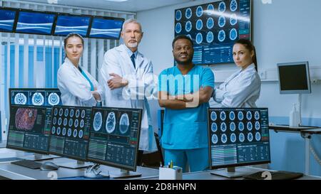 Un team diversificato di scienziati medici che si pone con le braccia incrociate nel laboratorio high-tech. Brain Sceince Neurologia Centro laboratorio di ricerca con multiplo Foto Stock