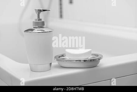 Liquido e sapone ordinario in bagno. Pulizia delle mani e del corpo. Foto Stock