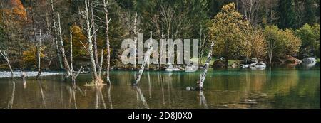 Vista panoramica sul laghetto con riflessi e boschi multicolori, in stagione autunnale lago in Val di Mello, Val Masino, Italia - lombardia Foto Stock
