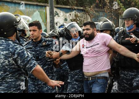 Beirut, Libano, 30 ottobre 2020. Un uomo viene arrestato come un piccolo gruppo di persone di Tripoli e Beirut si scontrò con le forze libanesi di sicurezza interna durante un tentativo del gruppo pan-islamico Hizb Ut Tahrir di marciare all'ambasciata francese per protestare contro quella che essi hanno visto come la posizione anti-islamica del presidente Emmanuel Macron. Le emozioni hanno corso alto come è stato sentito il profeta Maometto è stato disrispettato durante il suo mese di compleanno. Credit: Elizabeth Fitt/Alamy Live News Foto Stock