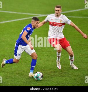 Gelsenkirchen, Germania. 30 Ott 2020. Amine Harit (L) di Schalke 04 vies con Sasa Kalajdzic di Stoccarda durante una partita tedesca della Bundesliga tra FC Schalke 04 e VfB Stuttgart a Gelsenkirchen, Germania, 30 ottobre 2020. Credit: Christopher Neundorf/Kirchner-Media/pool/handout via Xinhua/Alamy Live News Foto Stock