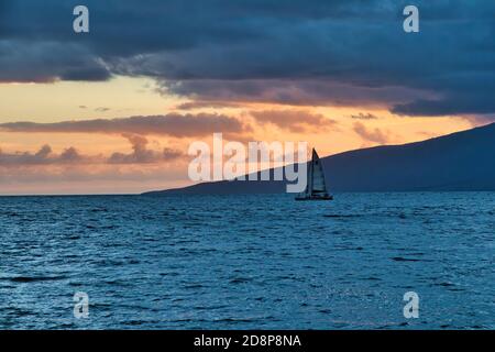 Spettacolare tramonto a Lahaina Bay con barca a vela e oceano blu profondo. Foto Stock