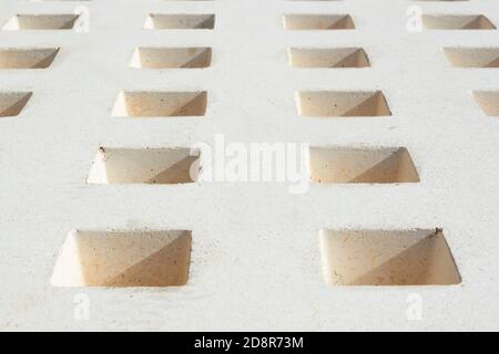 buchi nella pietra bianca di un banco che forma un modello dei quadrati. Andalusia, Spagna Foto Stock