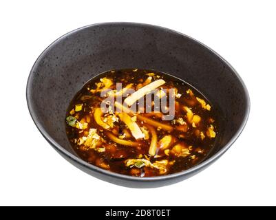 Cucina cinese - zuppa acida e piccante con gamberi e pollo (brodo con pollo, gamberi, tofu, bambù, funghi, uova e salsa di soia scura) in bla Foto Stock