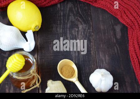 miele, miele di limone e zenzero, limone e zenzero, curcuma per una bevanda calda per il trattamento di raffreddori su fondo ligneo Foto Stock