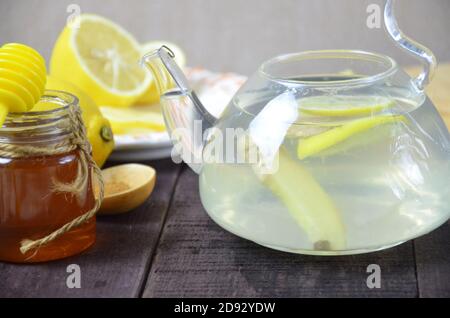 Tazza di tè allo zenzero con miele e limone sul tavolo di legno Foto Stock
