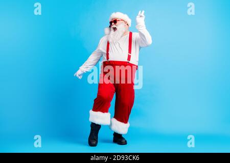 Foto a lunghezza intera di pazzo funky babbo natale con grande addome barba danza x-mas natale discoteca indossare presenze tute da sole copricapo Foto Stock
