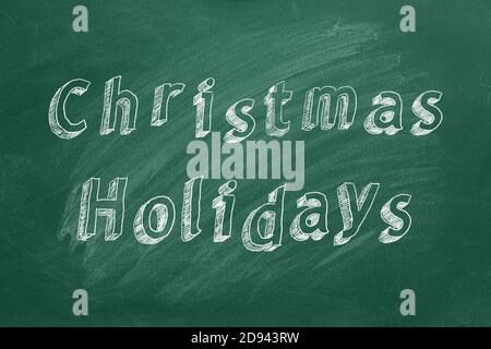 Testo di disegno a mano vacanze di Natale su lavagna verde Foto Stock