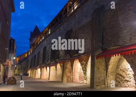 Vista notturna della torre medievale e delle mura della città nella città vecchia, Tallinn, Estonia Foto Stock