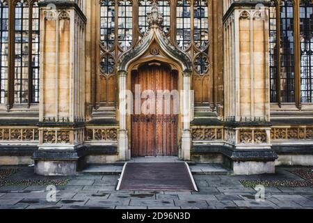 Oxford, UK - Marzo 02 2020: L'esterno della Divinity School di Oxford mostra una grande porta d'ingresso in legno, colonne e vetrate colorate Foto Stock