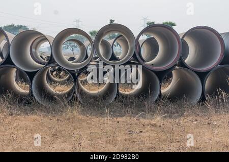 vista laterale dei tubi di ferro duttile immagazzinati in deposito di spazio aperto deposito. Foto Stock