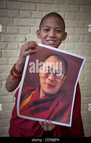 Dharamsala, India 2009 luglio. Un giovane monaco buddista tibetano posa con una foto del Dalai lama a Mcleod Ganj, il piccolo Lhasa. Foto Stock