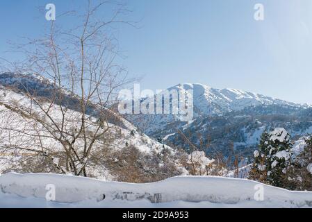 Inverno nelle montagne dell'Uzbekistan. Sulla strada per Beldersay resort. La catena montuosa di Tian Shan Foto Stock