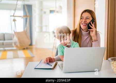 Occupato a lavorare la madre di non avere tempo per il suo bambino Foto Stock